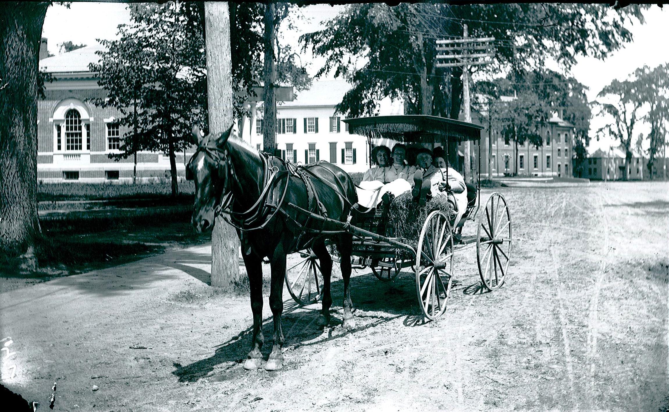 Horse and carriage on Main Street with Kennebunk Public Library and Unitarian Church in the background, c.1908